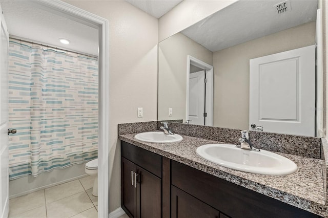 full bathroom with tile patterned floors, shower / bath combination with curtain, toilet, and vanity