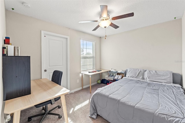 carpeted bedroom with ceiling fan and a textured ceiling