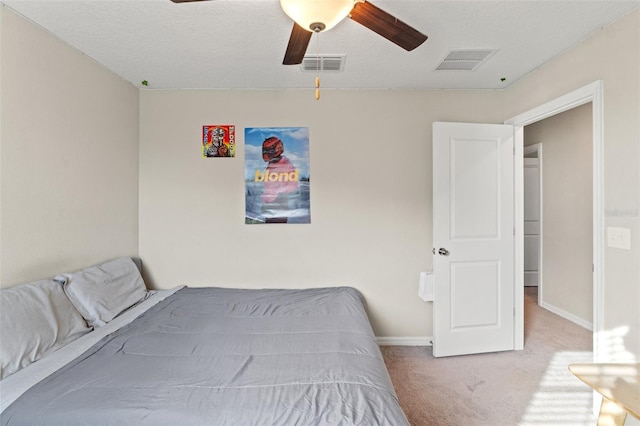 unfurnished bedroom with carpet flooring, ceiling fan, and a textured ceiling