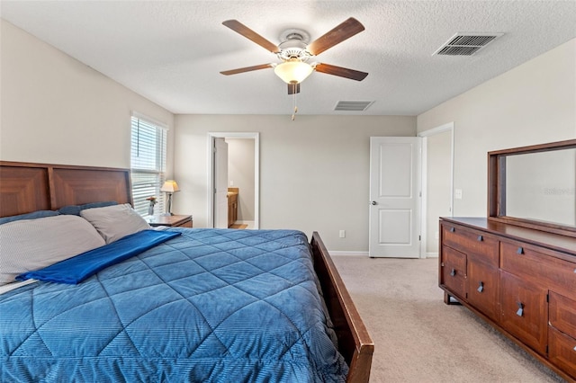 carpeted bedroom with ceiling fan, a textured ceiling, and connected bathroom