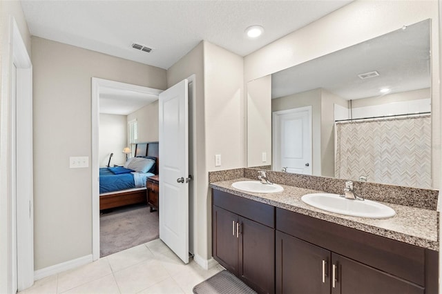 bathroom featuring tile patterned flooring, vanity, and a shower with shower curtain