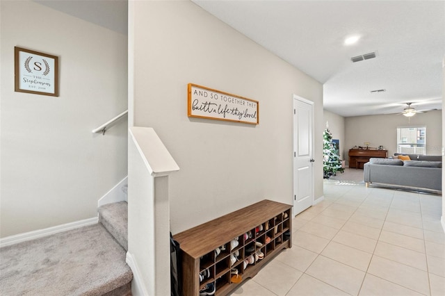 interior space with tile patterned floors and ceiling fan