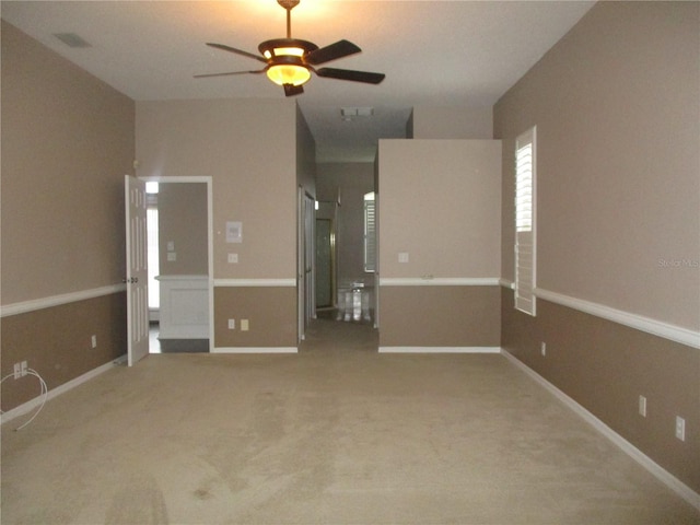 carpeted spare room with ceiling fan