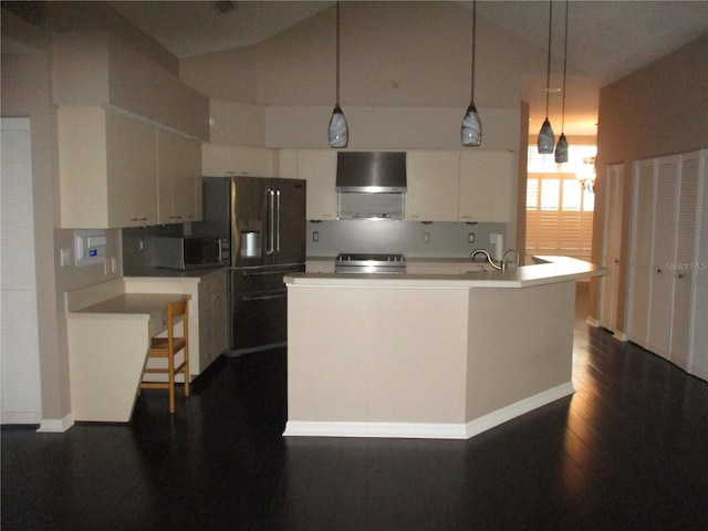 kitchen with wall chimney range hood, an island with sink, pendant lighting, white cabinets, and range