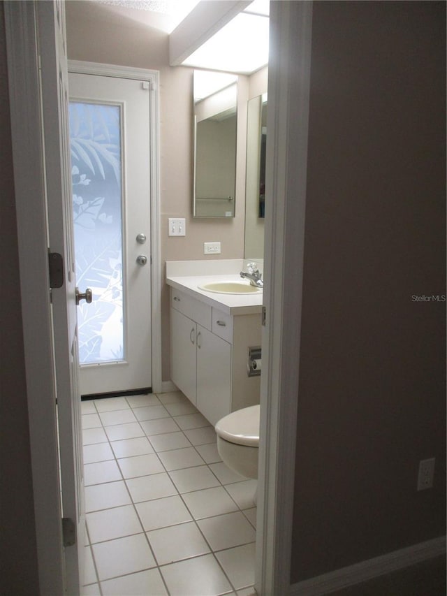 bathroom with tile patterned floors, vanity, and toilet