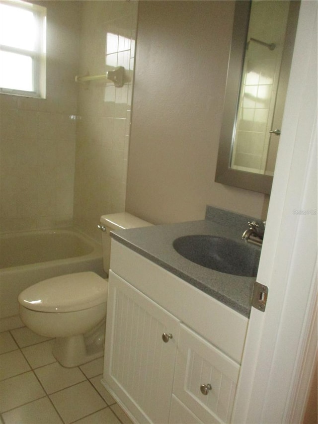 full bathroom featuring tile patterned flooring, vanity, tiled shower / bath combo, and toilet