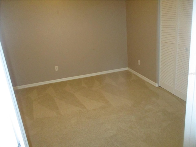 unfurnished bedroom featuring carpet flooring and a closet