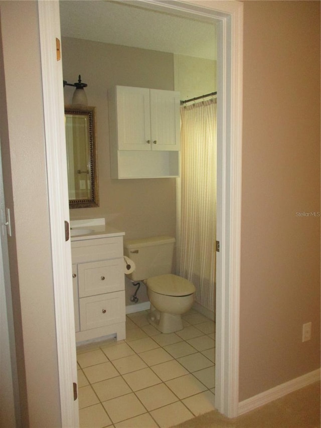 bathroom featuring toilet, vanity, and tile patterned floors