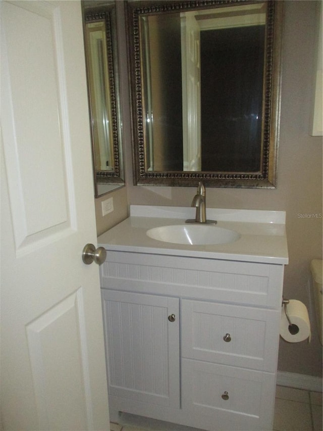 bathroom with tile patterned floors, vanity, and toilet