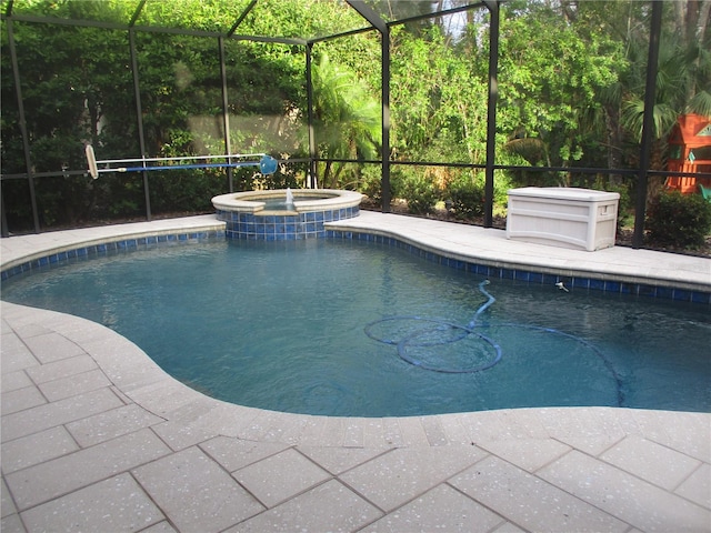 view of swimming pool with a lanai and an in ground hot tub