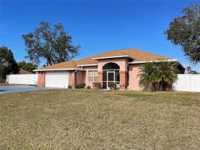 view of front of property with a front yard and a garage