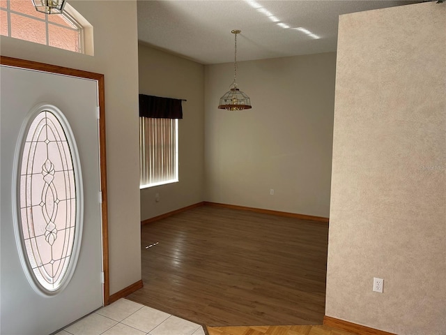 foyer entrance featuring a healthy amount of sunlight and light tile patterned flooring