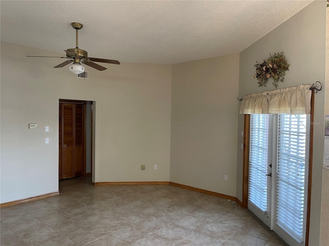 unfurnished room with ceiling fan and a textured ceiling