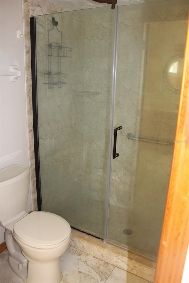 bathroom with toilet and walk in shower