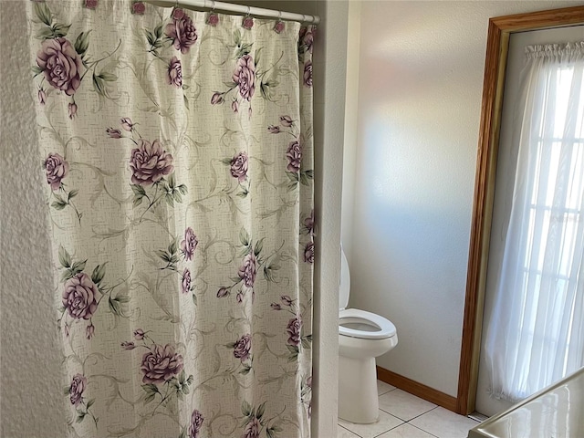 bathroom featuring tile patterned floors and toilet