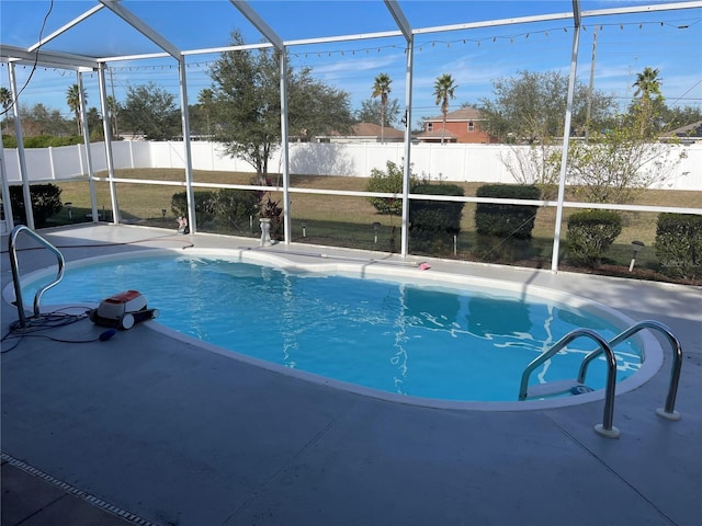 view of pool with glass enclosure and a patio