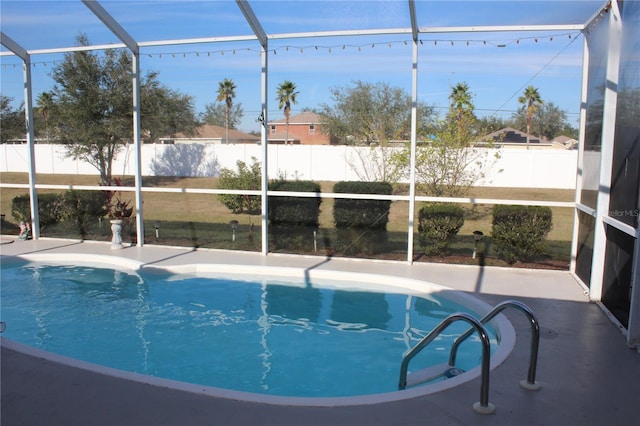 view of swimming pool with a lanai