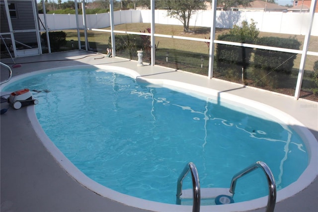 view of pool with glass enclosure