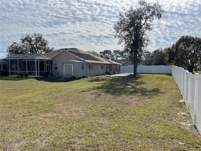 view of yard featuring glass enclosure