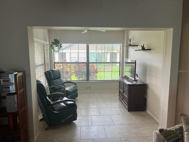 sitting room with ceiling fan and light tile patterned flooring