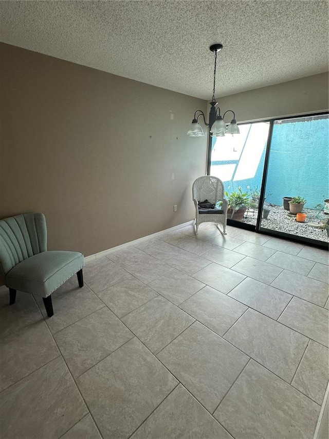 unfurnished room with a notable chandelier and a textured ceiling