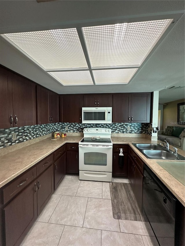 kitchen with sink, black dishwasher, white range with electric stovetop, dark brown cabinets, and light tile patterned floors