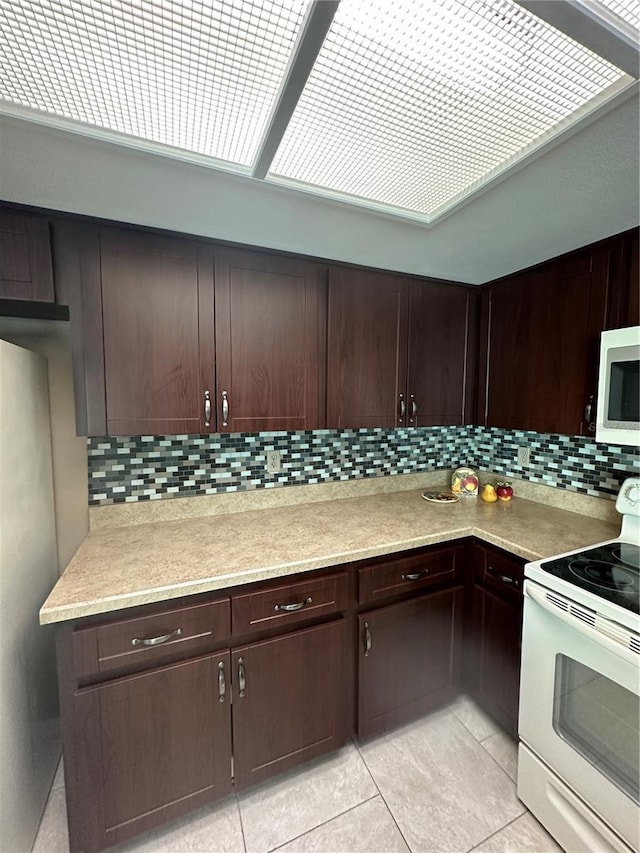 kitchen with decorative backsplash, dark brown cabinetry, white range with electric cooktop, and light tile patterned flooring