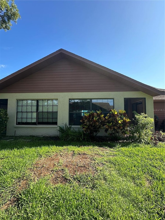 view of side of property with a lawn