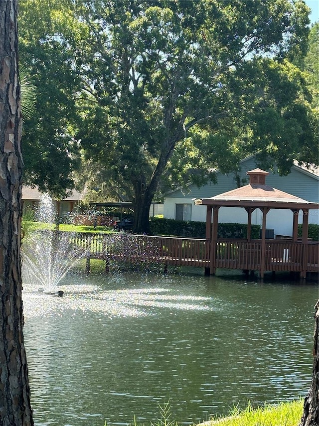 view of dock featuring a gazebo and a water view