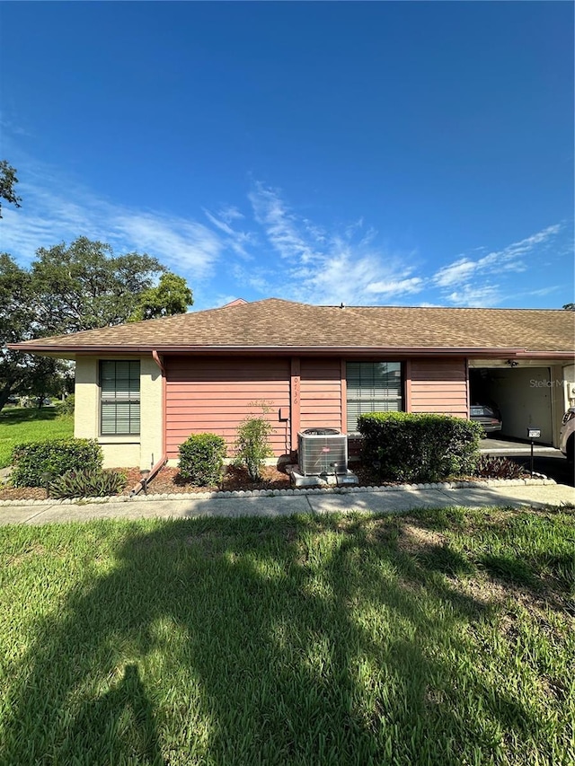 single story home with a front yard and central AC