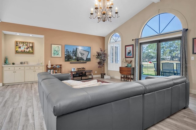 living room featuring beamed ceiling, high vaulted ceiling, an inviting chandelier, and light hardwood / wood-style flooring