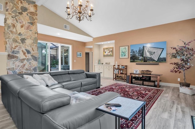 living room featuring beamed ceiling, light wood-type flooring, high vaulted ceiling, and a chandelier