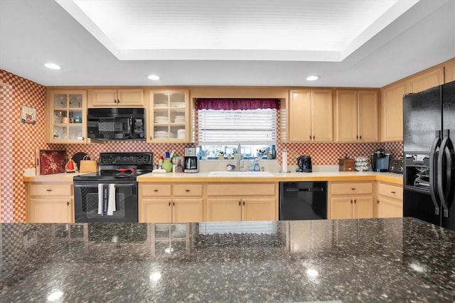 kitchen with backsplash, light brown cabinets, black appliances, and sink