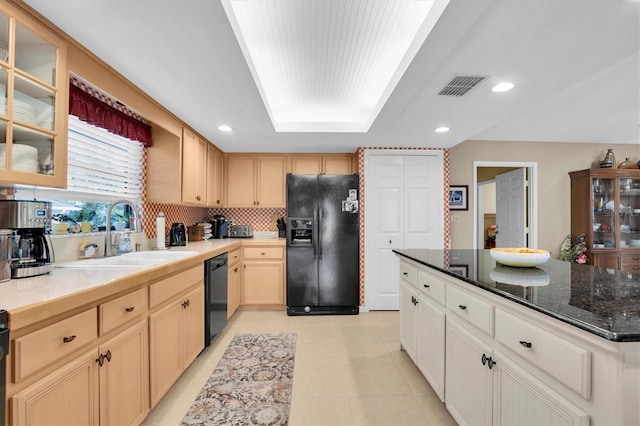 kitchen featuring sink, a raised ceiling, decorative backsplash, light brown cabinetry, and black appliances