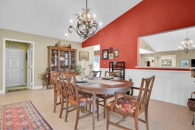 dining area with vaulted ceiling, light tile patterned floors, and a chandelier