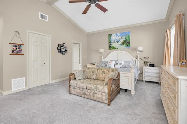 bedroom featuring beamed ceiling, ceiling fan, light colored carpet, and a closet