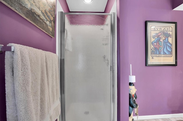 bathroom featuring a shower with shower door