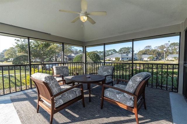 sunroom featuring ceiling fan and a healthy amount of sunlight