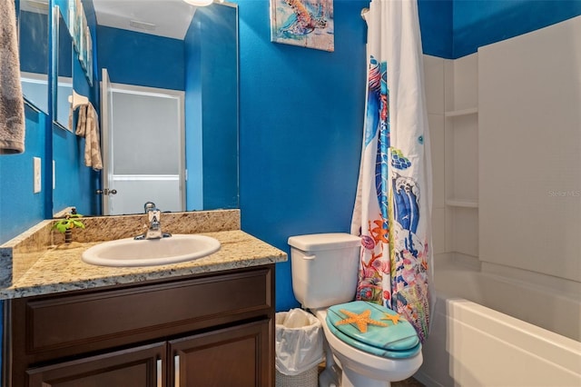 full bathroom featuring shower / bath combo, vanity, and toilet