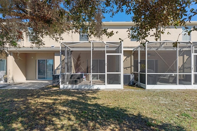 back of property featuring a patio, central AC, and a lawn