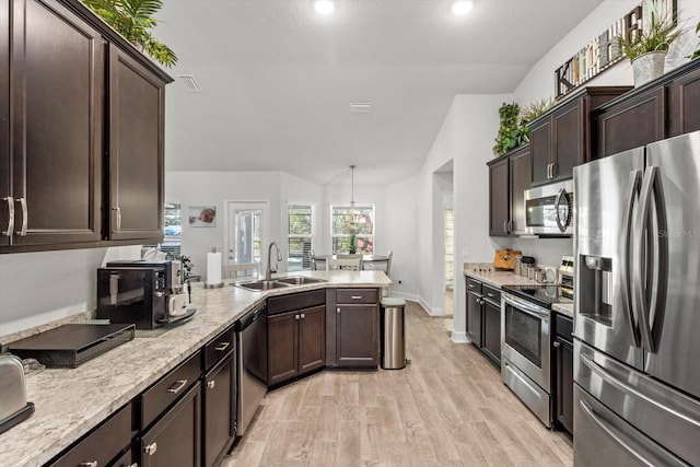 kitchen featuring dark brown cabinets, sink, stainless steel appliances, and lofted ceiling