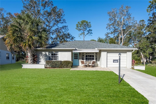 ranch-style home featuring a garage and a front lawn