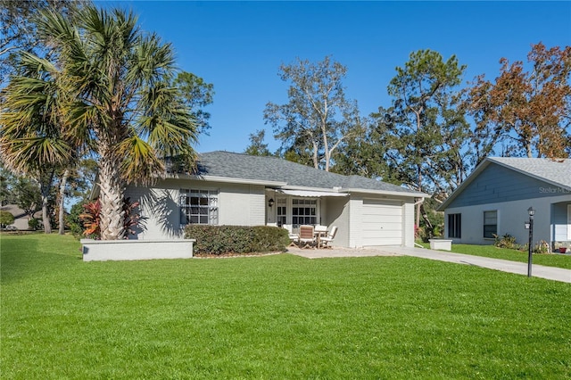 ranch-style home featuring a garage and a front yard