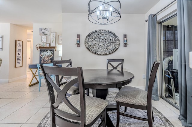 dining space with light tile patterned floors and an inviting chandelier