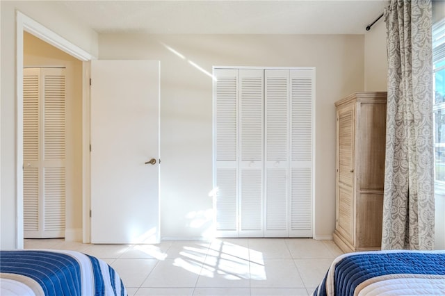 tiled bedroom featuring a closet