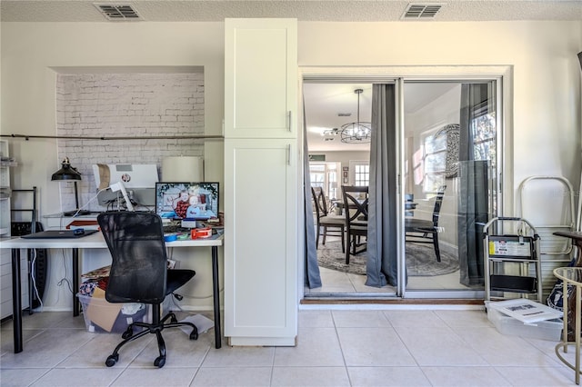 tiled office space featuring a textured ceiling and a notable chandelier