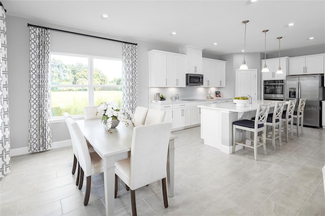 dining space featuring light tile patterned floors