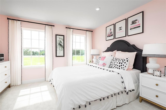 carpeted bedroom with multiple windows