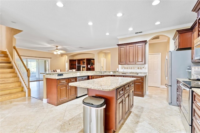 kitchen with a kitchen island, kitchen peninsula, sink, and appliances with stainless steel finishes