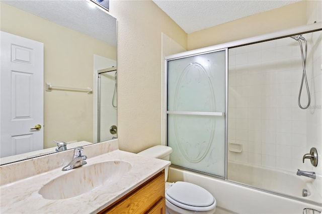 full bathroom with vanity, toilet, shower / bath combination with glass door, and a textured ceiling